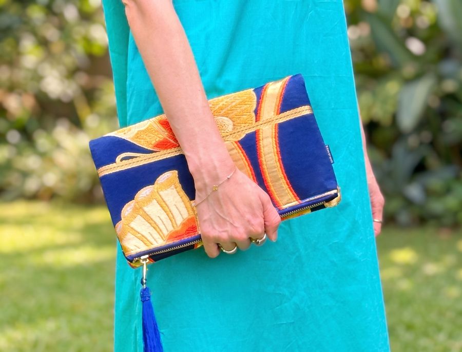 Toanoi kimono clutch bag with a red peony against a turquoise wall